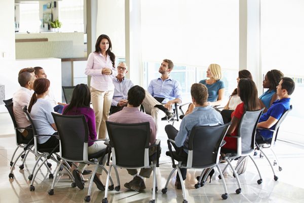 Businesswoman Addressing Multi-Cultural Office Staff Meeting